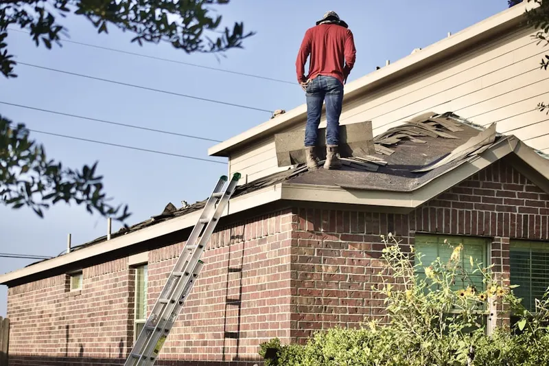 Professional roofer working on a residential roof in Sunrise